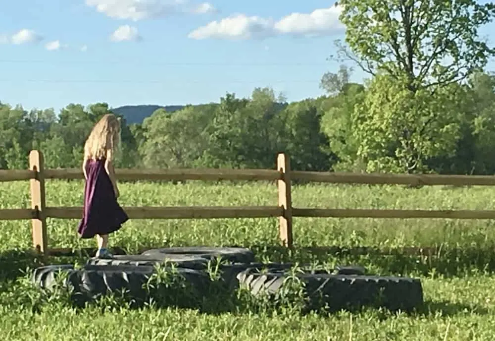 Cooperstown, Ny: Way More Than Baseball For A Family Getaway A girl hopping on tires in front of a split-rail fence in the yard of the kid-friendly red shed brewery.
