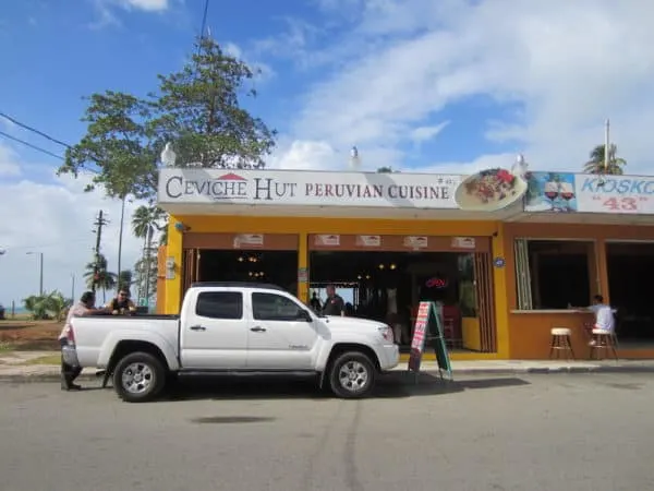 a peruvian food stall selling ceviche on a roadside in puerto rico.