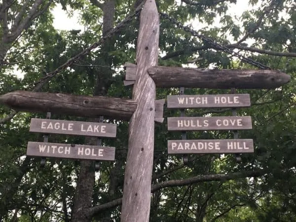 wooden signs marking the roads on acadia' national park's carriage roads.