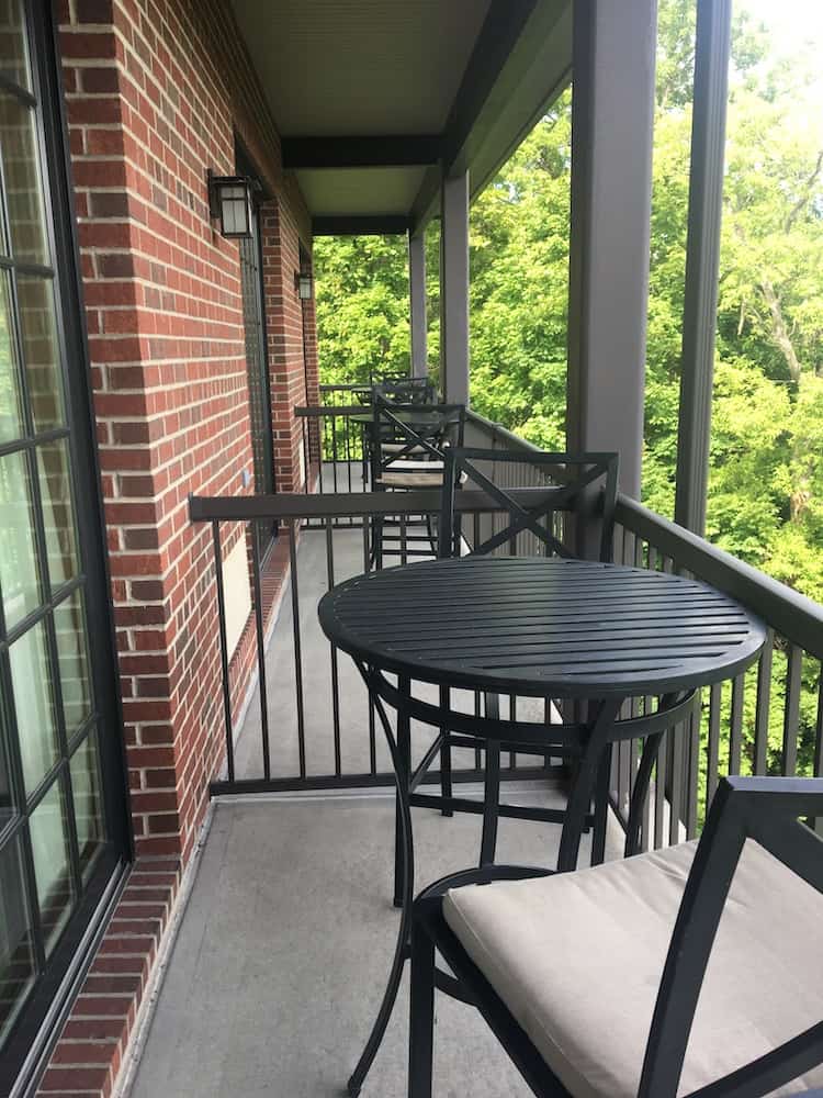 The rooms at the diamond mills hotel in saugerties all have balconies with high-top tables. Here is a series of them with the hotel's red brick facade