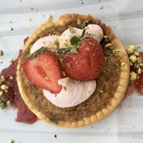 a seasonal strawberry and pistachio tart at the tavern, the modern american restaurant at the diamond mills hotel in the hudson valley.