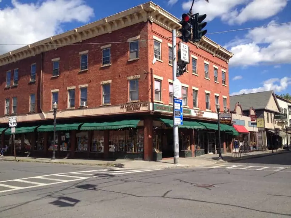 the long, awninged facade of the inquiring minds books, a bookstore, café and gathering spot on main street in saugerties, ny.