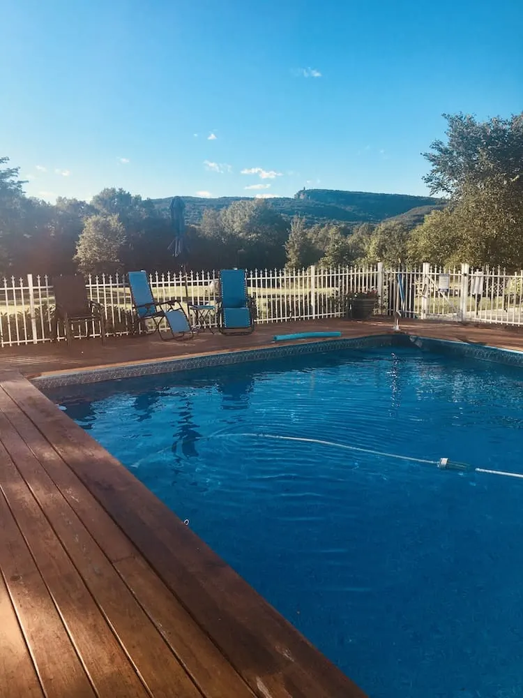 the pool, deck and mountain view at mountain meadow b&b in upstate, new york