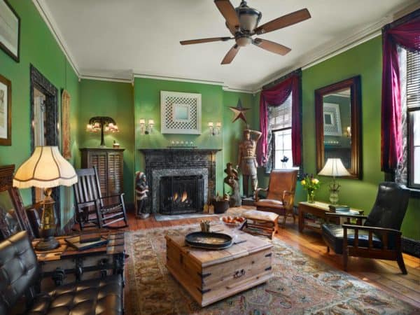 the common rooms at olivia's bridge street inn are 19th centure smart. this one has bright green walls, leather chairs and a working fireplace.