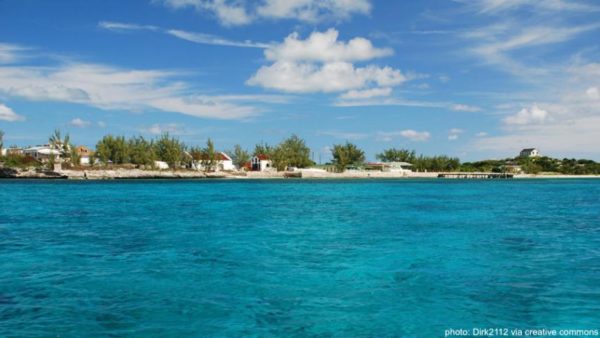 the white cottages and small beaches of historic cockburn harbor in south caicos, as seen from the water.