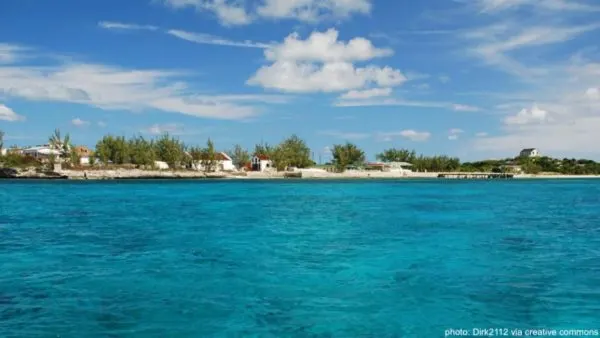 the white cottages and small beaches of historic cockburn harbor in south caicos, as seen from the water.