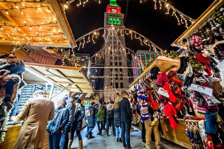 the denver christmas market features german food, american sweets, and a variety of vendors, all below the city's holiday lights. 
