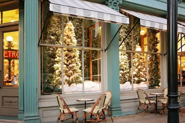 Discover The Best Local Christmas Activities Across The U.s. the elegant christmas windows at savannah's paris market shop with bistro tables outside.