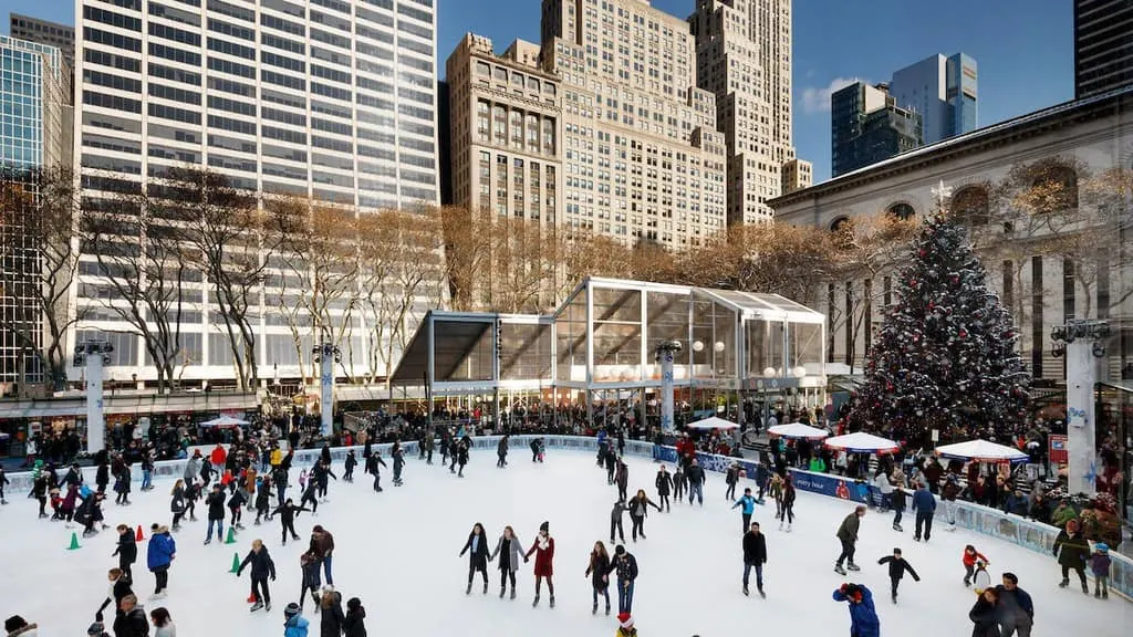 the ice skating rink and winter village shops in bryant park, next to the ny public library.