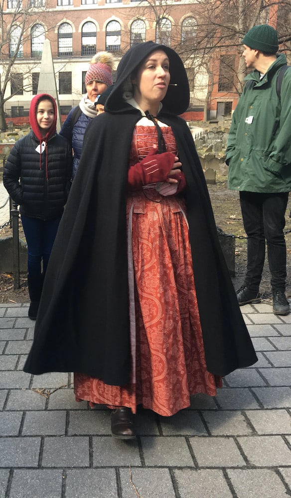 A costumed interpreter guides visitors along boston's freedom trail