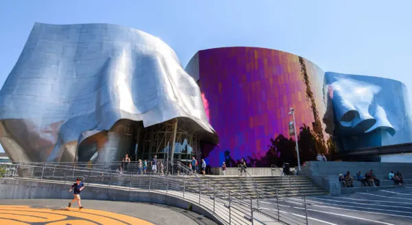 seattle's museum of pop culture is in a building that looks like 3 inverted metal cups, a distinct, frank gehry design.