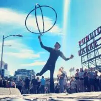 a busker juggles outside of Pike Place Market in Seattle