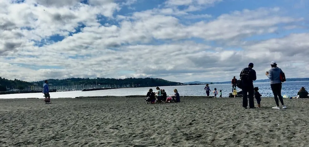 the wide beach on elliott bay at golden gardens park in seattle.