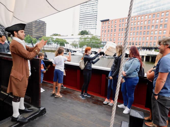 Colonists cheer the tea-throwing rebels at the boston tea party