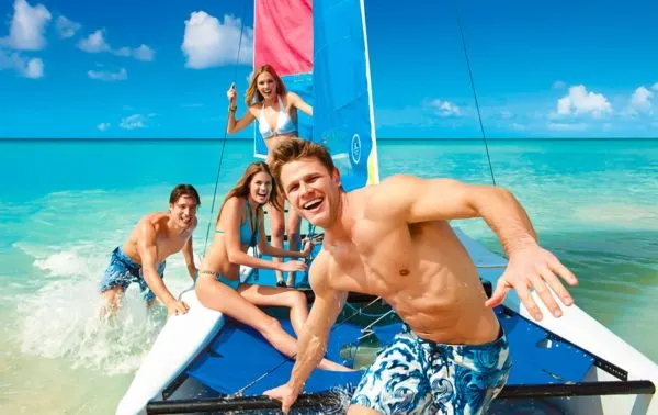 10 Tips For A Familymoon That's Romantic And Kid-Friendly Teens bonding during a trip on a small catamaran at beaches.