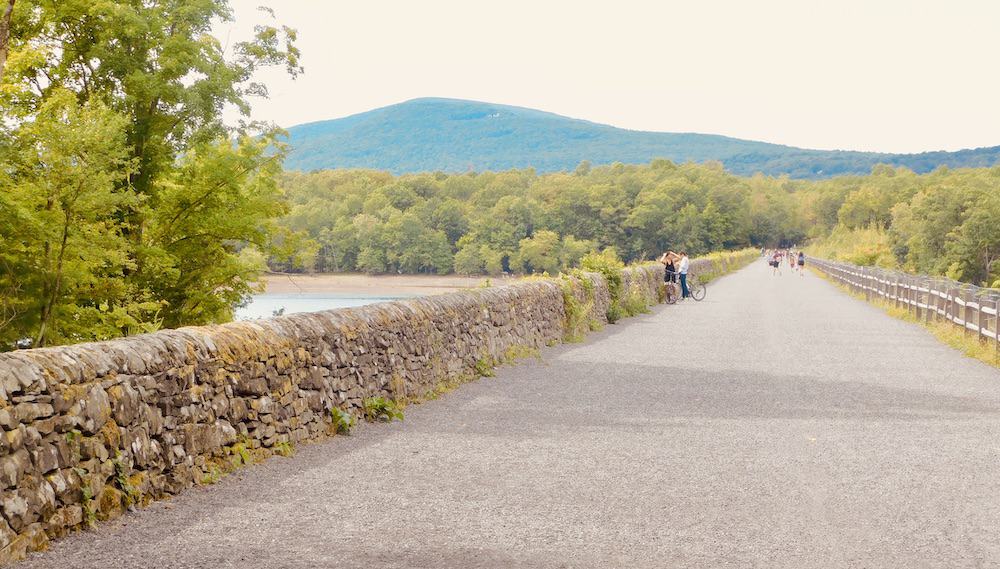 The ashoken rail trail is a popular hiking and biking spot for a weekend getaway to the hudson valley.