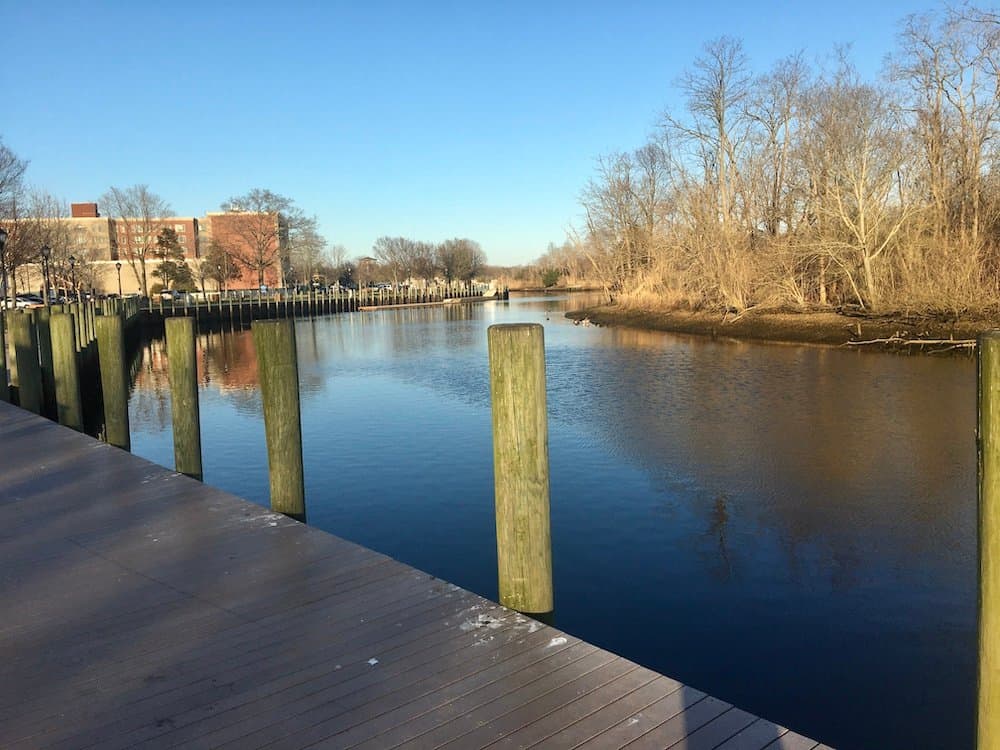 The peconic river winds its way along riverhead's riverwalk park.