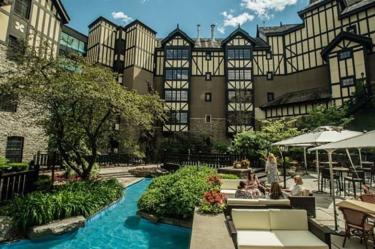 The landsacped pool and patio a thte old mill hotel in toronto is ideal for some couple time.
