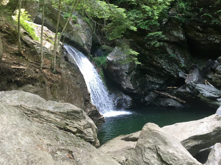 one of a few waterfalls surrouned by large boulders that you pass on your bingham falls hike in smugglers notch