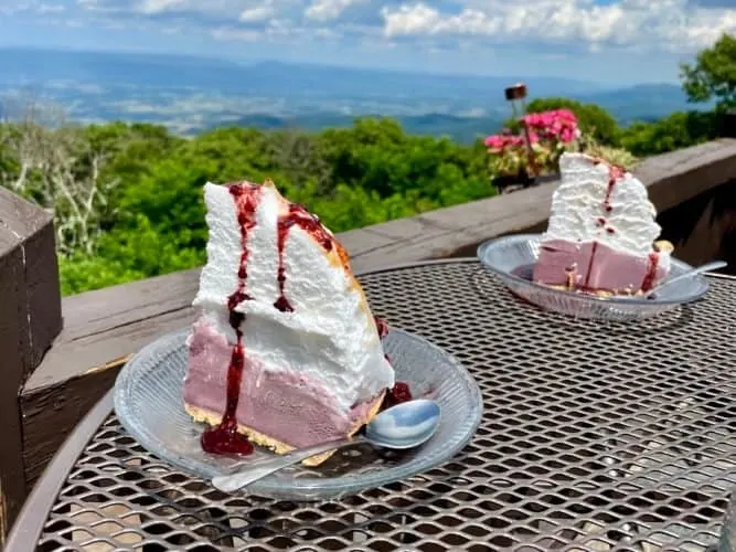 2 slices of merengue-topped blackberry-ice cream pie with a view of the shenandoah valley.