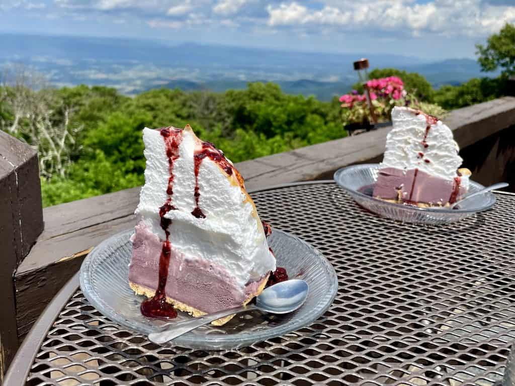 2 slices of merengue-topped blackberry-ice cream pie with a view of the shenandoah valley.