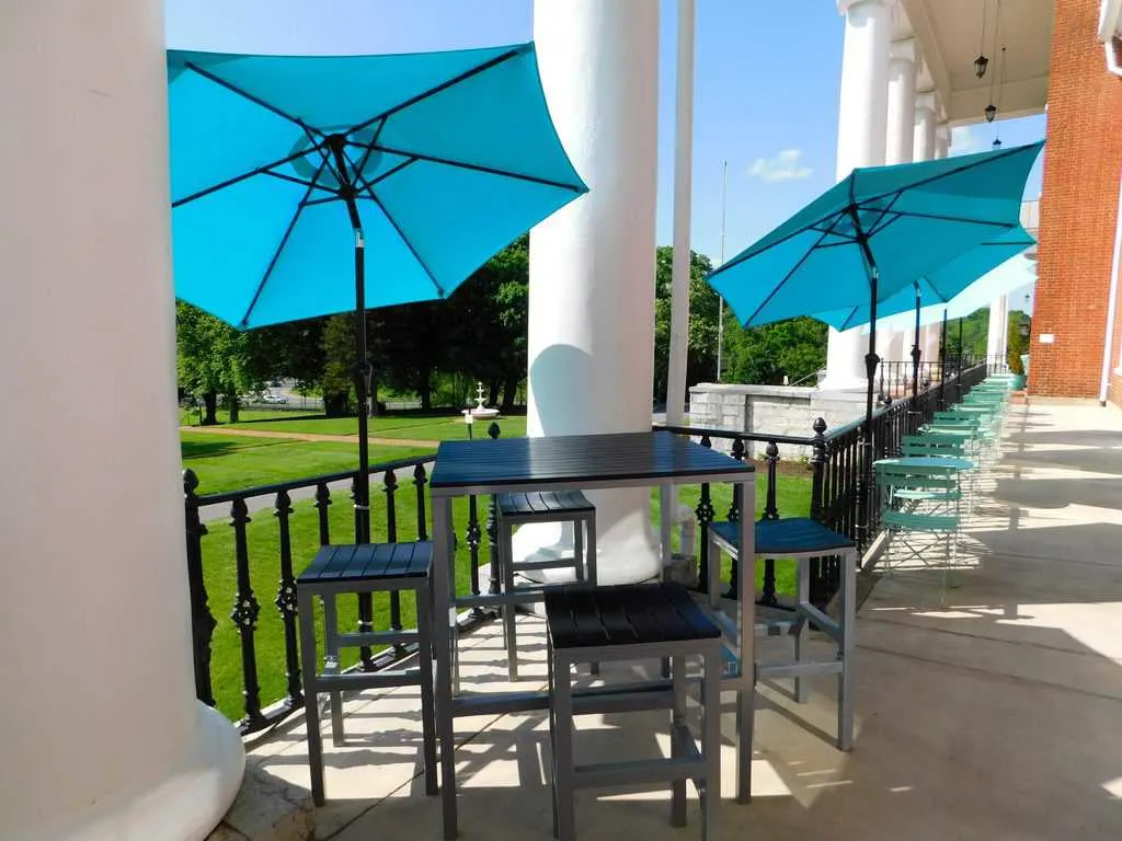 the long, sunny front porch of the blackburn inn in staunton, va