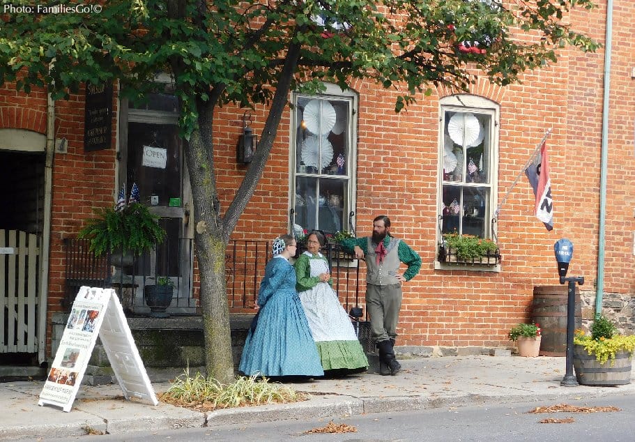 interpreters in civil-war-era dress stand outside one of the historic homes people can tour in gettysburg, which is ideal for a 2-night getaway.i