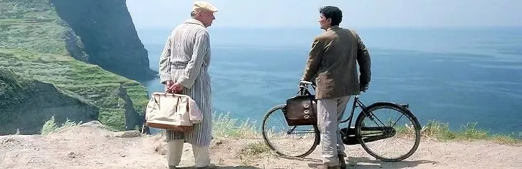 pablo neruda and his postman talk on a cliff overlooking the sea in il postino, an atmospheric italian movie.