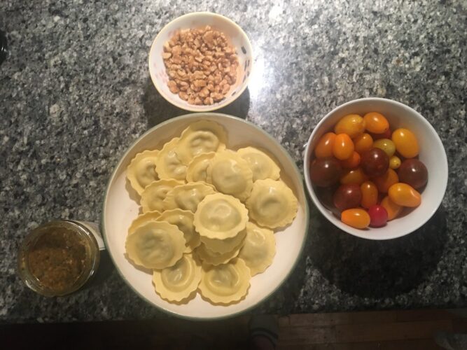 ravioli, walnuts, cherry tomatoes and parmesan-asiago pesto are the ingredients for our italian night pasta dish