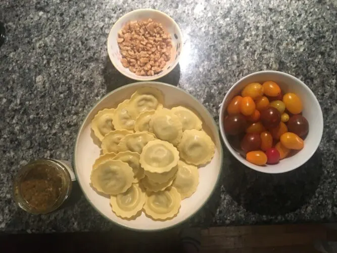 8 Molto Bene Ideas Staycation Italian Night Theme Party ravioli, walnuts, cherry tomatoes and parmesan-asiago pesto are the ingredients for our italian night pasta dish