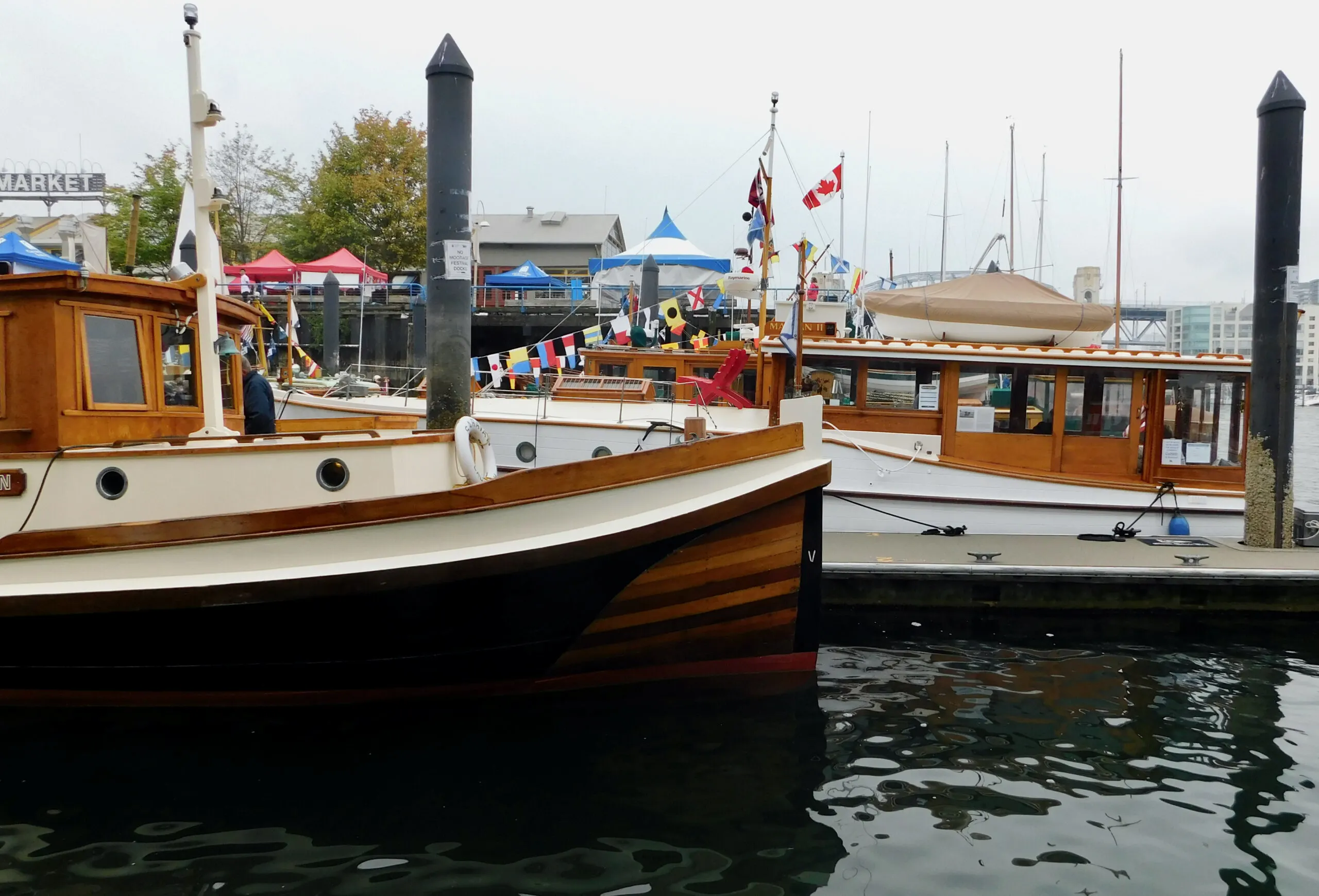 water taxis sit by the docks of granville island in vancouver