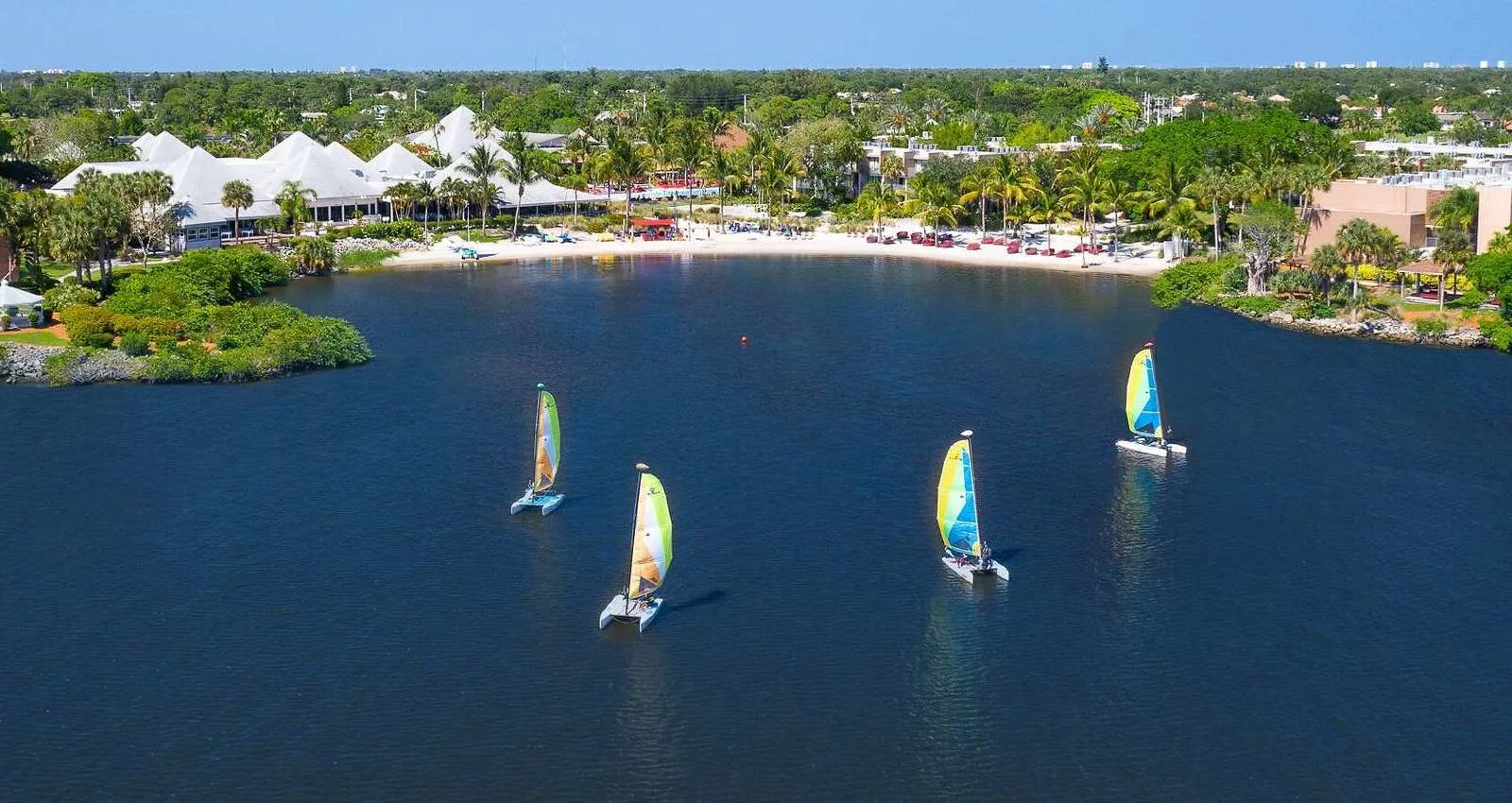 the tranquil bay at club med sandpiper is great place for water sports like saling on the 4 small catamarans. this makes it perfect for a winter vacation.