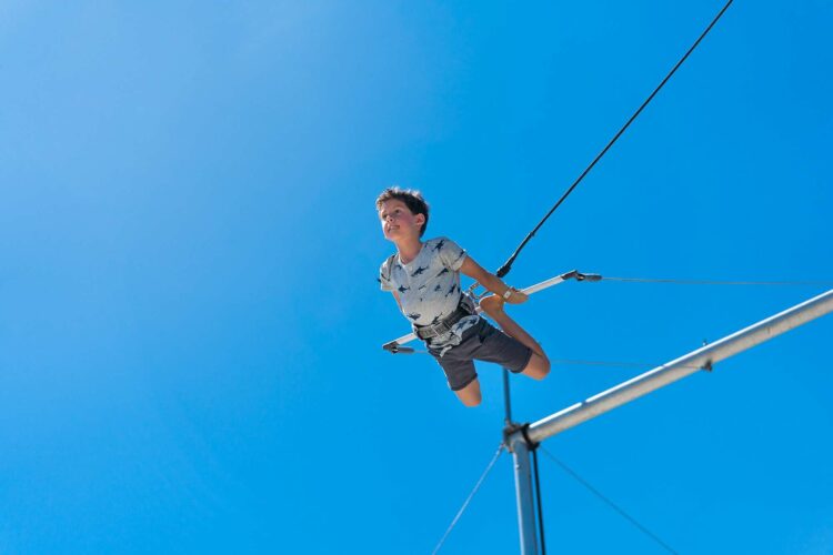 A boy flies on a trapeze at club med sandpiper, a florida beach resort with a circus school. It's a rare all-inclusive beach resort within the u. S.