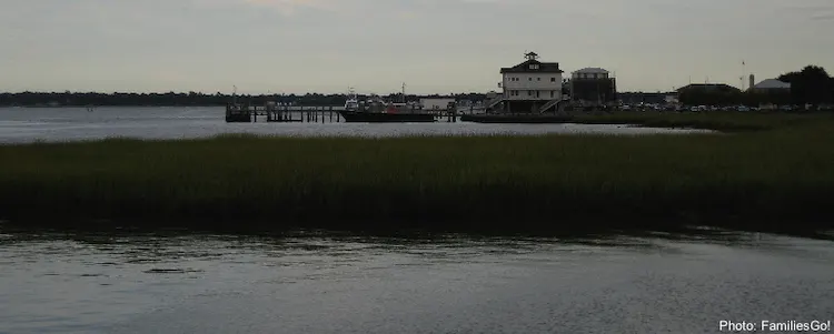 charleston' waterfront with pieres,tall grass and small buildings.