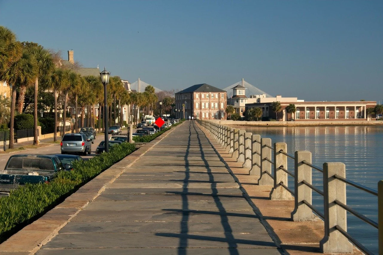 charleston's sea wall is a lovely lace to stroll to look a the city's harbor, boats annd colorful homes.