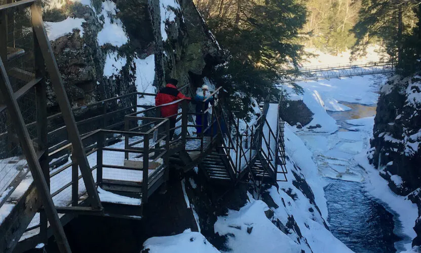 Lake Placid In Winter: Chock Full Of Things To Do With Kids A dad and daughter walk along the suspended walks above the frozen rivers and waterfalls of high falls gorge in the adirondacks.