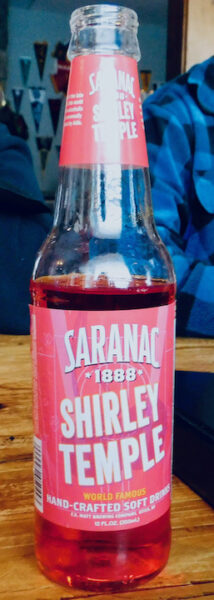 Saranac soda's bottled shirley temple cocktail is bright red and easy to find in adirondack towns.