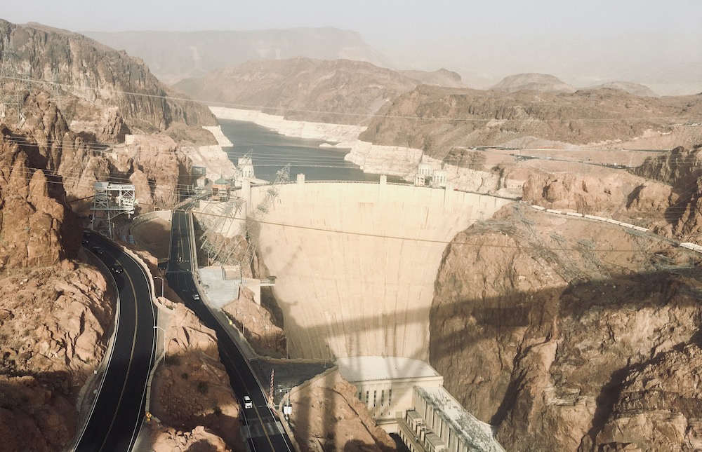 A view of the hoover dam from the memorial bridge shows the enormous size of the dam and lake mead behind it