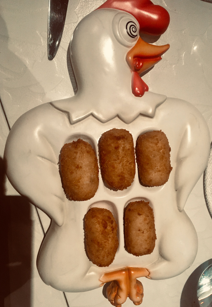 Chicken croquettes on a plate that looks like a chicken at jaleo in the cosmopolitan hotel in las vegas. A good option for both teens and parents.