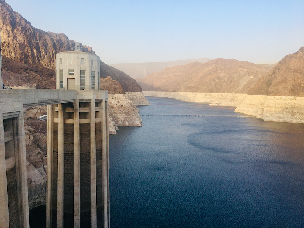 A view of lake mead and one of the hoover dam's control towers from the top of the dam