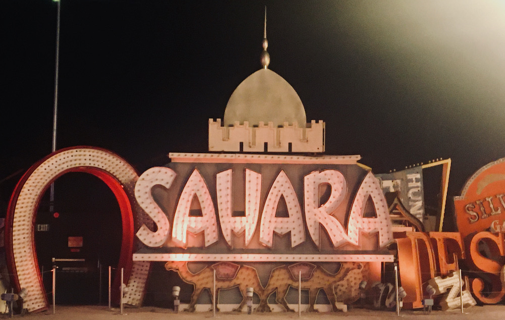 a partially restored sign for the sahara hotel at the neon museum's boneyard