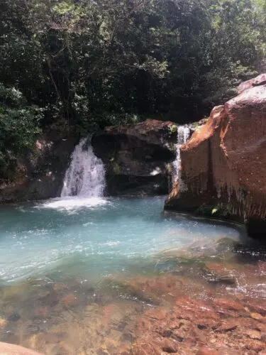 a waterfall and swimming hole at hacienda guachipelin.