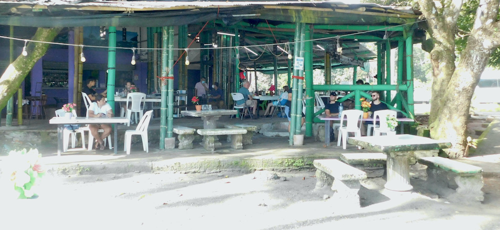 An open air café sits next to the mañuel antonio beach in costa rica