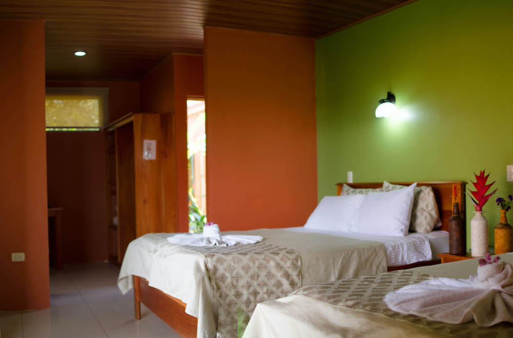 the rooms at miradas arenal are done in green and orange colors and are basic but comfortable. 
