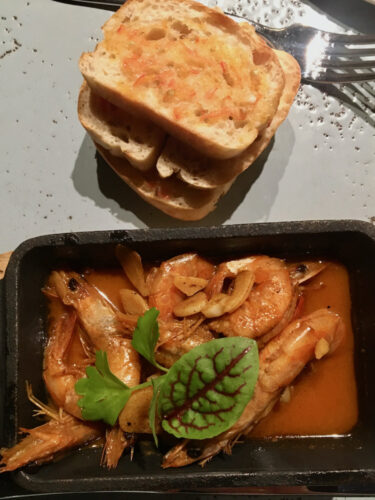 Garlic shrimp and tomato toast at the don juan bar at the parador reosrt in costa rica.