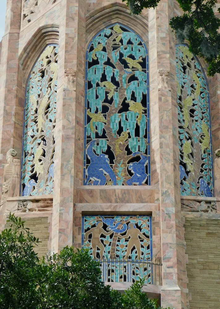 a garden of eden motif on bok tower features mosaic baboons, birds, animals and trees. 