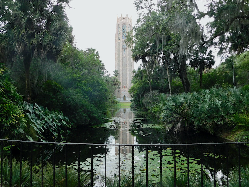 Bok tower is a cochina bell tower surrounded by lush green florida gardens and a reflecting pool
