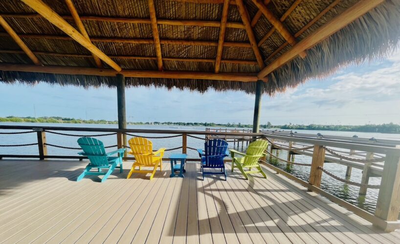 Adirondack chairs with a lake view at camp margaritaville in florida.