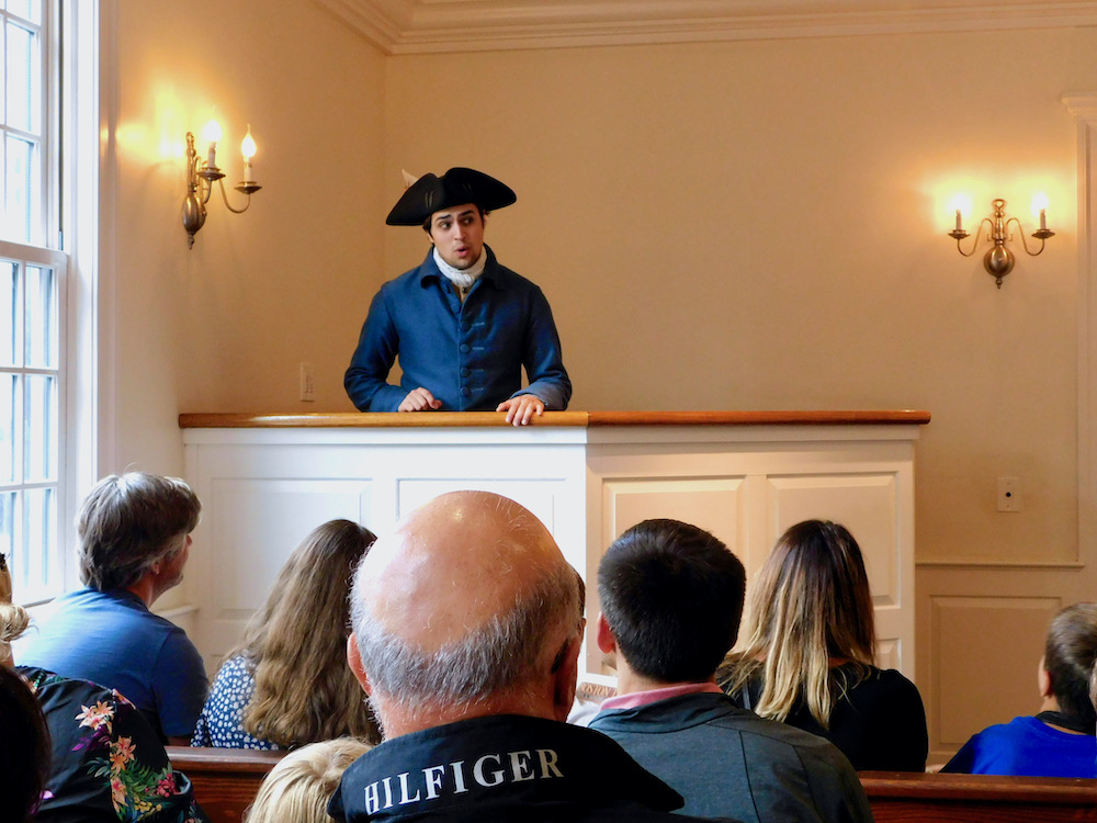 a boston patriot explains to a crowd why the tea party protest is necessary to make the colonies' position clear to england -- just one way boston is a top destination for historic vacations in th northeast.