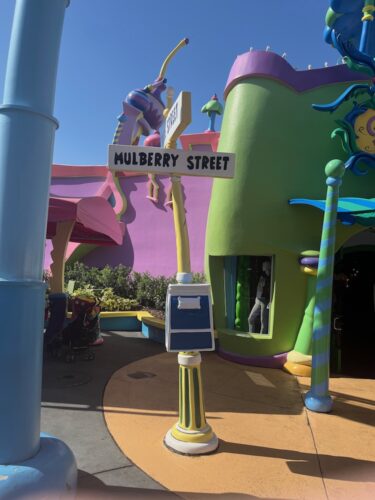 seuss landing at unversal studios is a bright-colored immersive rendering of seuss's books, like mulberry street. 